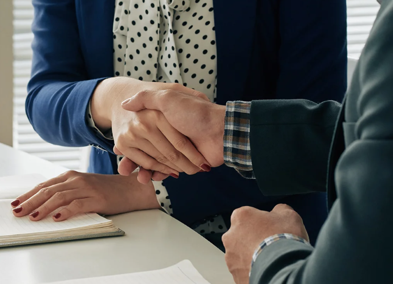 Business people shaking hands after successful meeting