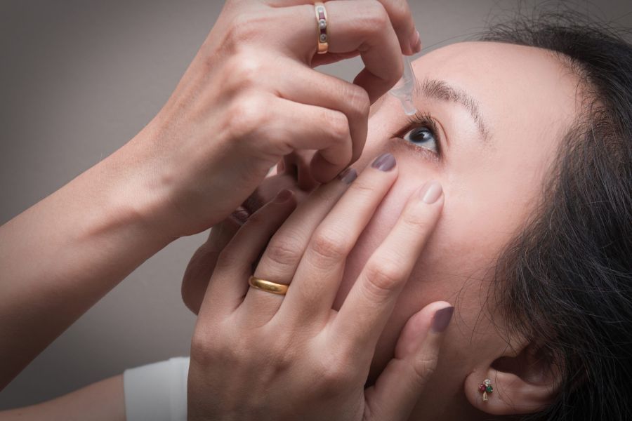 Photo of person applying an eye drop